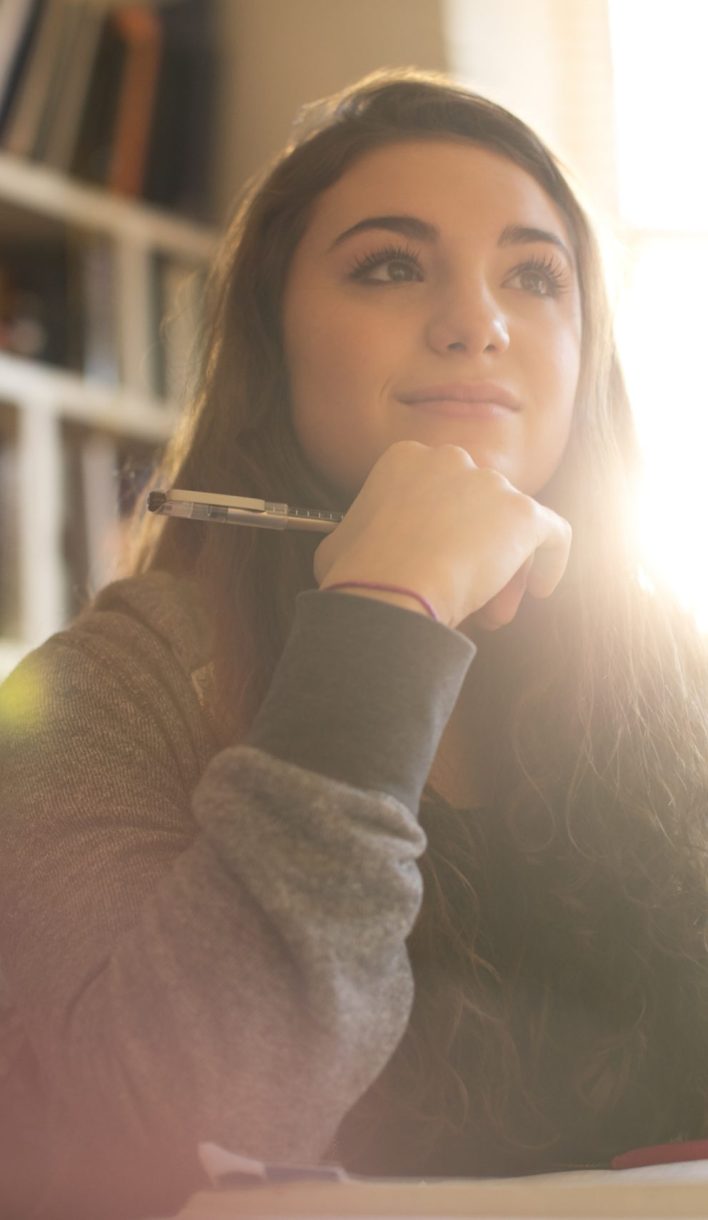 Pensive teenage girl with digital tablet